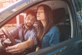 Driving test. Young serious woman driving car feeling inexperienced, looking nervous at the road traffic for information Royalty Free Stock Photo