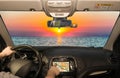 Driving using GPS towards scenic sunset on the mediterranean sea Royalty Free Stock Photo