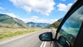 Driving view from side of car mirror mountain valley. Beautiful landscape of a road in the mountains on a sunny day with Royalty Free Stock Photo