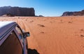 Driving in Wadi Rum desert in Jordan, middle east. Off road car driving on sand in desert Royalty Free Stock Photo