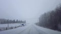 Driving whiteout snow weather on dangerous road conditions in winter. Driver point of view POV blizzard snow