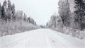 Driving through the winter forest on snowy road, first view. Camera outside the window on steadicam. Winter landscape in