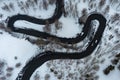 Driving on winter roads trough forest winding road in the mountains Royalty Free Stock Photo