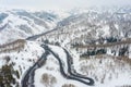 Driving on winter roads trough forest winding road in the mountains Royalty Free Stock Photo