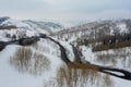 Driving on winter roads trough forest winding road in the mountains Royalty Free Stock Photo