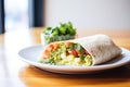 drizzle of salsa verde on a breakfast burrito