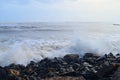 Drizzle of Water Drops with Hitting of Sea Wave to Rocks on Shore with Blue Sky - Ocean Natural Aqua Background Royalty Free Stock Photo