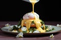 drizzling hollandaise sauce over poached eggs