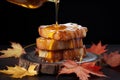 drizzling maple syrup on french toast stack