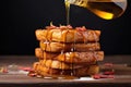 drizzling maple syrup on french toast stack