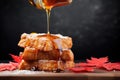 drizzling maple syrup over a stack of french toast