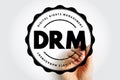 DRM Digital Rights Management shown as a bold circular stamp held by a hand, emphasizing protection, control, licensing, and Royalty Free Stock Photo