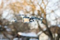 DJI Mavic 2 Zoom Quadcopter in air. Remote control of drone, winter time. Illustrative