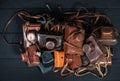 Drohobych, Ukraine - 02 February, 2019: Heap of 35mm retro cameras in leather covers, top view