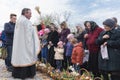 Drohobych, Western Ukraine - April 08, 2017: Priest consecrates Easter baskets with sacred water