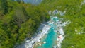 DRONE: Active tourists kayaking and rafting on glassy Soca river in the summer. Royalty Free Stock Photo