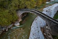 Drone aerial of ancient, stoned , arched bridge on the Portaikos river in autumn. Trikalla pyli village Thessaly Greece Royalty Free Stock Photo