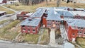 Drone aerial of Byron Health Center demolition with side view of abandoned old hospital deconstruction