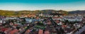 Drone aerial evening panorama of Sighisoara, Romania with Citadel and Biserica din Deal rising above the skyline. View towards the