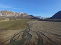 Drone aerial image of twisting, winding, streams in a fluvial river valley in northeast Greenland