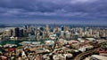 Drone Aerial view of Sydney Harbour Sydney CBD NSW Australia. cloudy dark skies, clear turquoise waters. Royalty Free Stock Photo