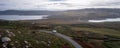 Drone Aerial Panoramic View Of A Camper Van In Green And Red Landscape With Atlantic Ocean In Tourinan Cape In Galicia, Spain