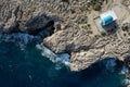 Drone aerial scenery of Cape Greco peninsula with christian church on the rocks. Turquoise ocean water