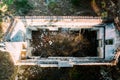 Drone aerial scenery of an abandoned building in the forest. Rooftop of a deserted house
