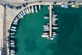 Drone aerial scenery of a fishing port. Fishing boats and yachts moored in the harbour