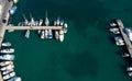 Drone aerial scenery of a fishing port. Fishing boats and yachts moored in the harbour