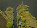 Drone aerial scenery of a lake with boat moored on the lake side. Aerial view of lake landscape with small fishing boats at the e Royalty Free Stock Photo