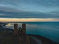 Drone aerial shot of Remains of Reculver church towers at early october sunrise early october sunrise