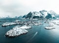 Drone aerial shots, photos in Henningsvaer, Lofoten Norway during cloudy weather winter time with snowy epic mountains Royalty Free Stock Photo