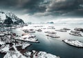 Drone aerial shots, photos in Henningsvaer, Lofoten Norway during cloudy weather winter time with snowy epic mountains Royalty Free Stock Photo