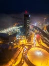 Drone aerial view of Europa Bussines and Shopping center tower in city of Banska Bystrica during winter evening