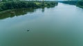 Drone aerial view fisherman is fishing sitting on an inflatable boat in lake Royalty Free Stock Photo