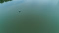 Drone aerial view fisherman is fishing sitting on an inflatable boat in lake