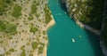 Drone aerial view of huge canyon with river in the middle with small boats adventuring