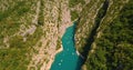 Drone aerial view of huge canyon with river in the middle with small boats adventuring