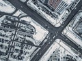 Drone aerial view of intersection of streets or road highways in a busy car traffic modern city at winter time