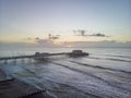 Drone aerial view landscape image of Worthing pier on Sussex coast in England at dawn Royalty Free Stock Photo