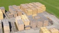 DRONE: Aerial view of neatly organized stacks of pine wood lying in a lumberyard Royalty Free Stock Photo