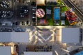 Drone aerial view of parking lots with cars and entertainment park at night. Bright crowded shopping mall Royalty Free Stock Photo