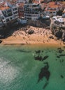 Drone aerial view of Praia da Rainha and Conceicao next to the historic city centre of Cascais, Portugal