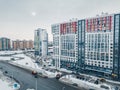 Drone aerial view of a residential highrise building in modern city district with busy road and