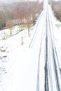 drone aerial view of a road in a snow-covered landscape, winter time transportation concept Royalty Free Stock Photo