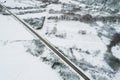 Drone aerial view of a road in a snow-covered landscape, winter time concept Royalty Free Stock Photo