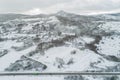Drone aerial view of a road in a snowy landscape Royalty Free Stock Photo