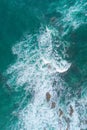 drone aerial view of ocean waves breaking against rocks on the coastline Royalty Free Stock Photo