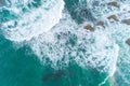 drone aerial view of the sea waves breaking against some rocks Royalty Free Stock Photo